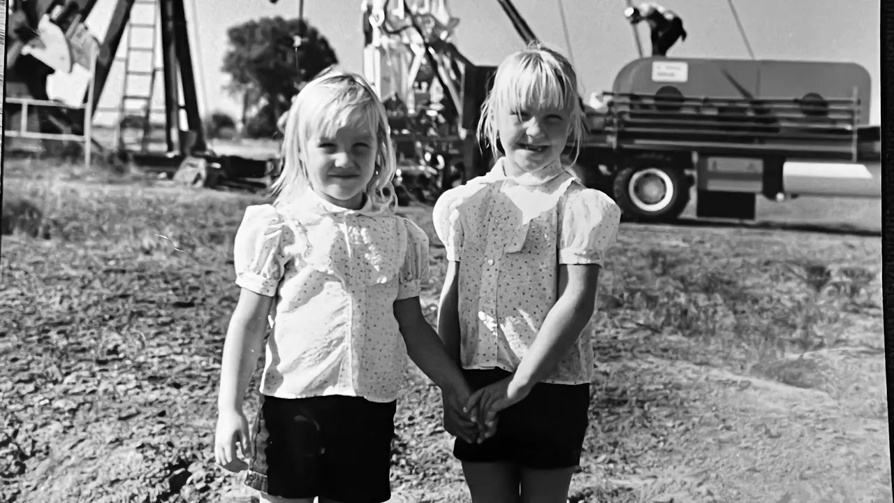 Tressa and Andrea Arnett as young girls at an oilfield site