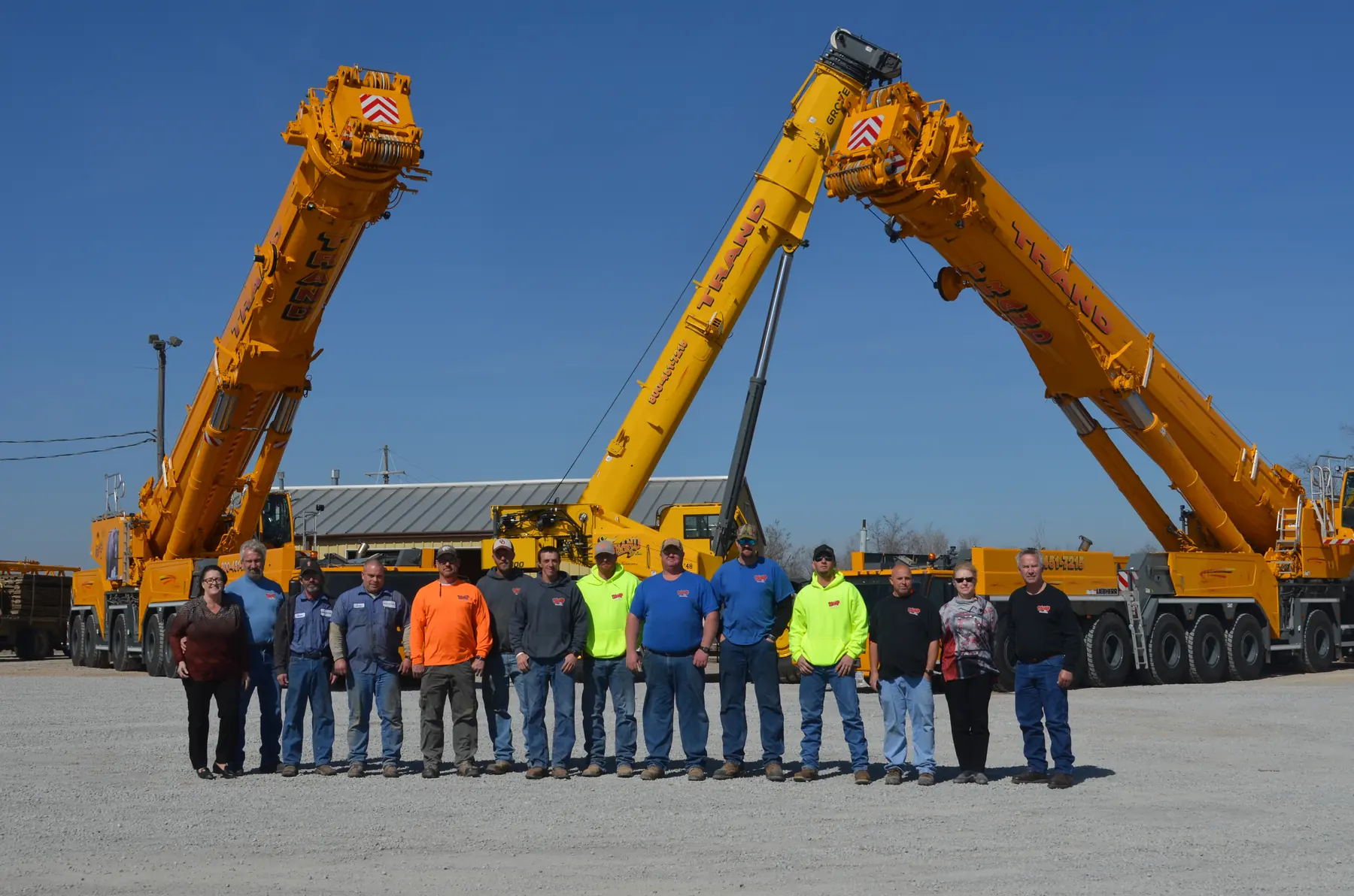 The Trand team lined up in front of the crane fleet